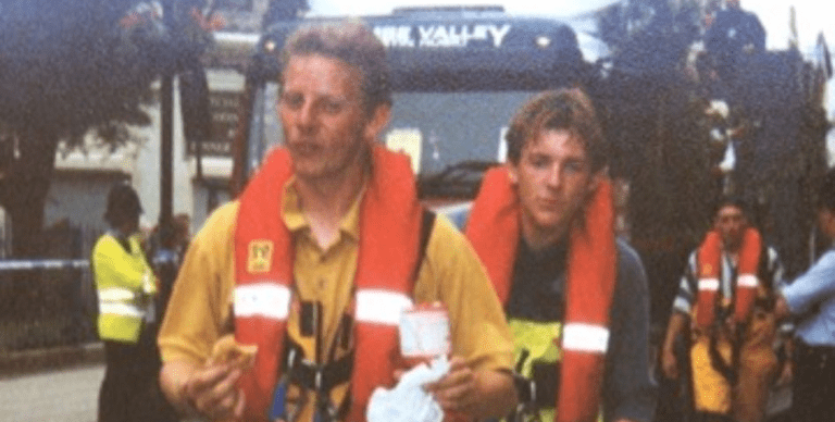 Captain Simon in a yellow boiler suit with a bright orange life jacket on